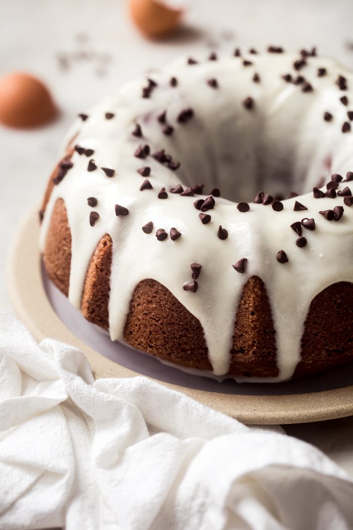 vanilla bundt cake with cream cheese icing and chocolate chips